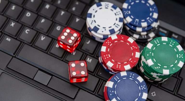 Computer keyboard with gambling chips and dice
